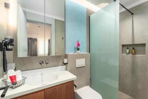 a bathroom with a sink and a shower at Arriba Rooms in Poreč