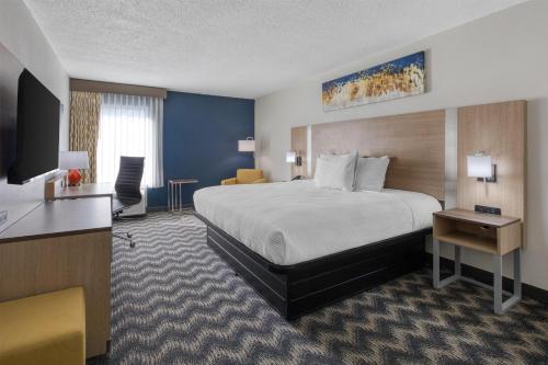 a hotel room with a bed and a desk at Best Western Greensboro Coliseum Inn in Greensboro