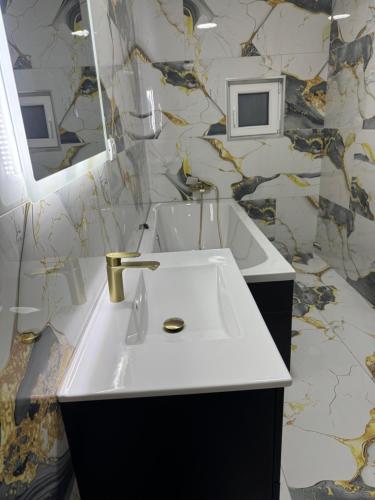 a bathroom with a white sink and a mirror at Timi&Amos2 in Caransebeş