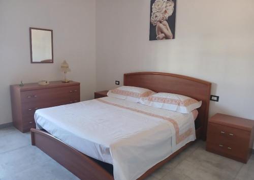a bedroom with a large bed and two night stands at Il Centro in Tergu