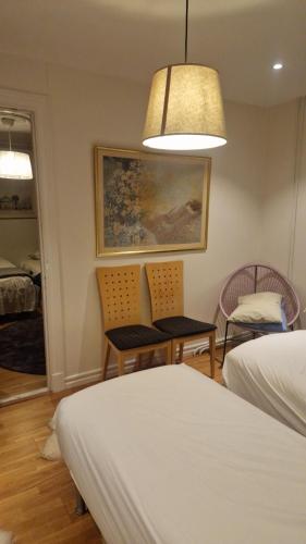 a bedroom with a bed and two chairs and a table at Cosig house in Nygård