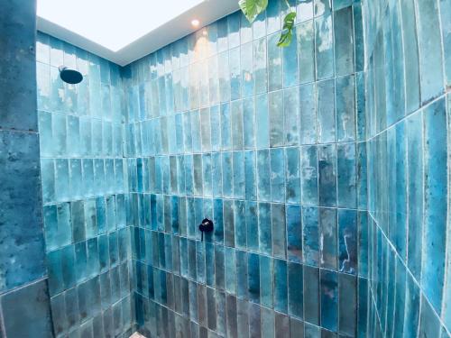 a blue tiled shower with blue tiles on the wall at The Modern Alpine Oasis - Mountain Views - Rainfall Shower - Perfect for Couples in Wanaka