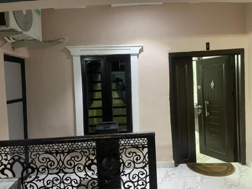 a room with a mirror and a door and a bench at Knock inn luxury apartment in Benin City