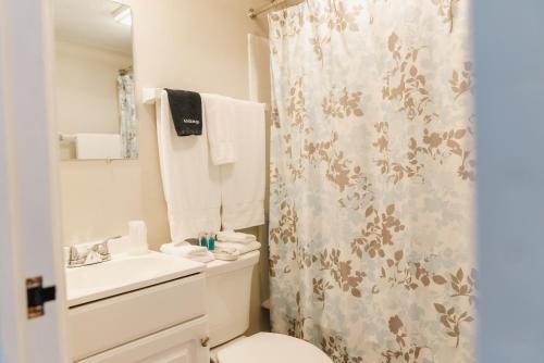 a bathroom with a toilet and a shower curtain at General Denver Hotel in Wilmington
