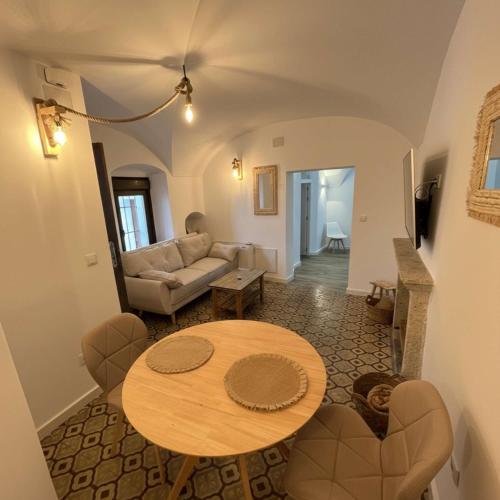 a living room with a table and a couch at Apartamentos Cañón de la Rinconada in Trujillo