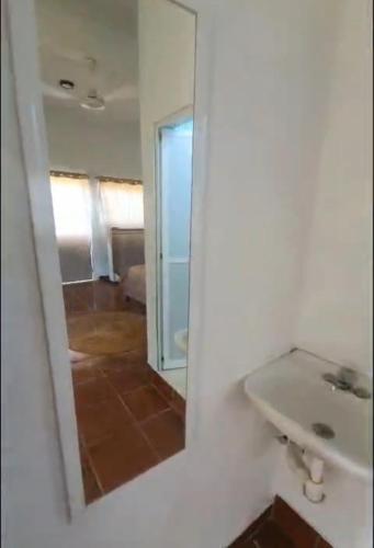 a bathroom with a sink and a mirror at Estudio Arena in Brisas de Zicatela