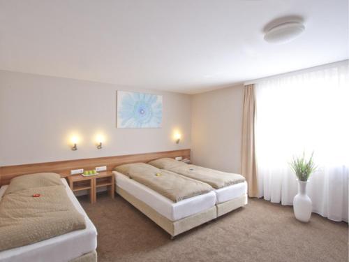 Postel nebo postele na pokoji v ubytování Hotel Sielminger Hof