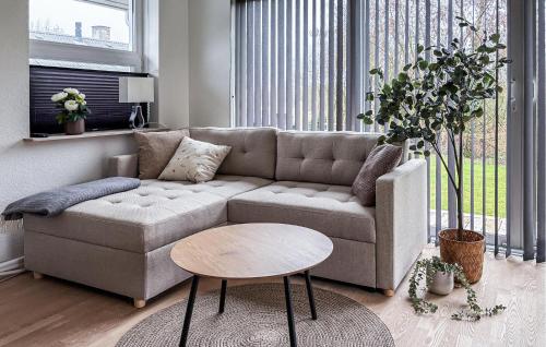 a living room with a couch and a table at 3 Bedroom Cozy Home In Haderslev in Haderslev