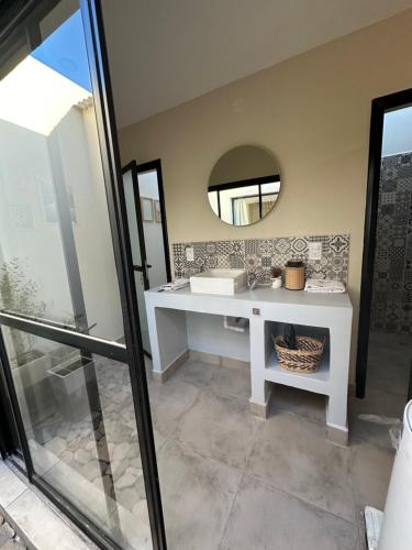 a bathroom with a white sink and a mirror at Glamping Salta in Cabra Corral