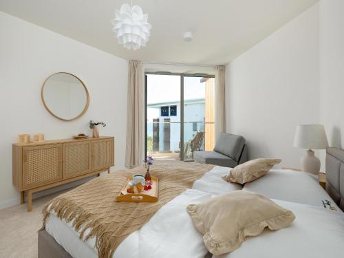 a bedroom with a bed with a tray of food on it at Large apartment with sea view, indoor pool in Pobierowo