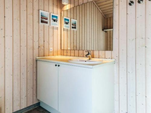 a bathroom with a white sink and a mirror at 8 person holiday home in Vig in Vig