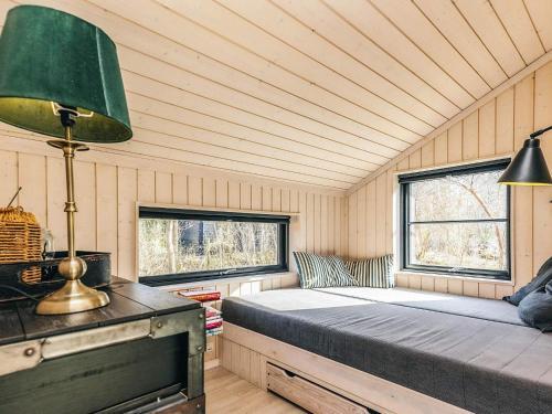 a bedroom with a bed in a room with two windows at 8 person holiday home in Vig in Vig
