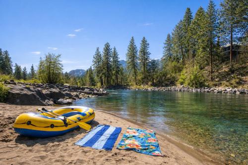 a raft and towels on the shore of a river at Riverside Loft Suite home in Leavenworth