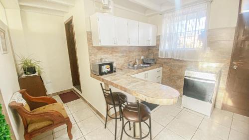 a kitchen with a counter with a sink and a counter at SUITE AMOBLADA TODO INCLUIDO in Quito