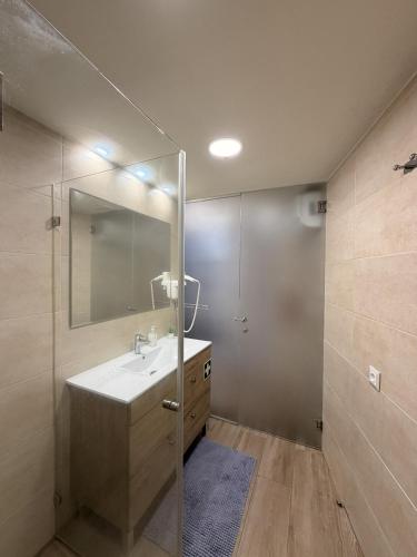 a bathroom with a sink and a mirror at Piedade Guest House - Lisbon South by Rosado in Almada