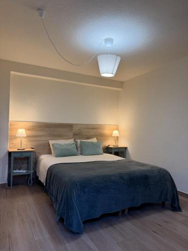 a bedroom with a large bed with two night stands at Piedade Guest House - Lisbon South by Rosado in Almada