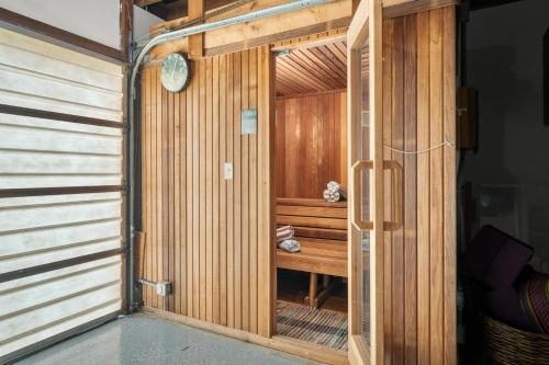 a wooden sauna with a clock on the wall at After Dune Delight MCA#50643 in Manzanita