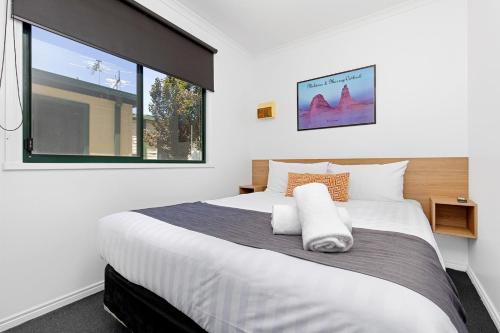 a bedroom with a large bed and a window at All Seasons Mildura Holiday Park in Mildura