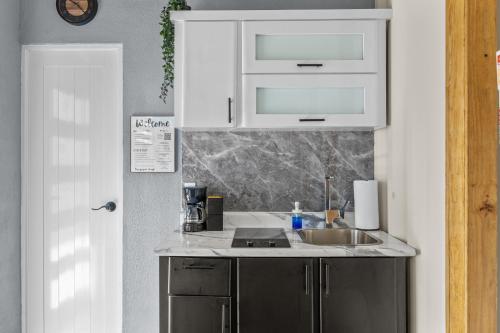 a kitchen with a sink and a counter top at Cozy 1BR Beachside Apartment Entre Olas in Vega Baja