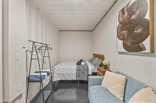 a living room with a couch and a bed at Cozy 1BR Beachside Apartment Entre Olas in Vega Baja