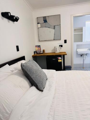 a bedroom with a bed with a pillow on it at Mount Pleasant Hotel in Mount Pleasant