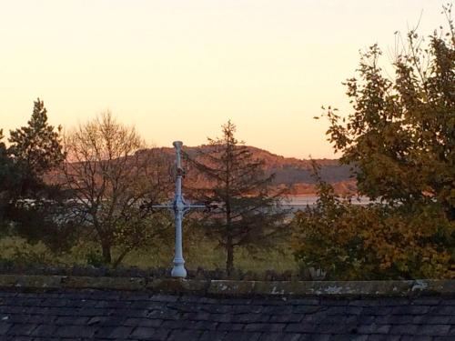 a white cross on top of a roof at Grange Boutique Hotel in Grange Over Sands