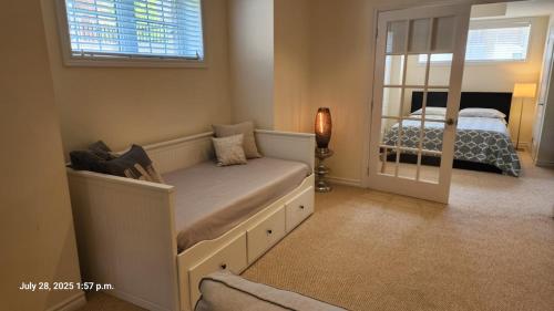 a small bedroom with a bed and a mirror at Spacious 2 BR, 3 beds, sleeps 6, kitchen, laundry in Richmond Hill