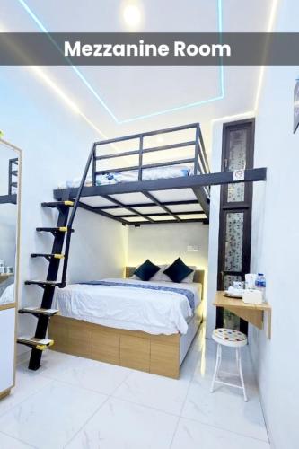 a bedroom with a bunk bed and a spiral staircase at Laswi Syariah Guest House in Bandung