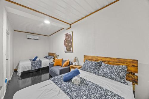 a bedroom with two beds and a couch at Beachside 1BR Apartment Sleeps 4 in Vega Baja