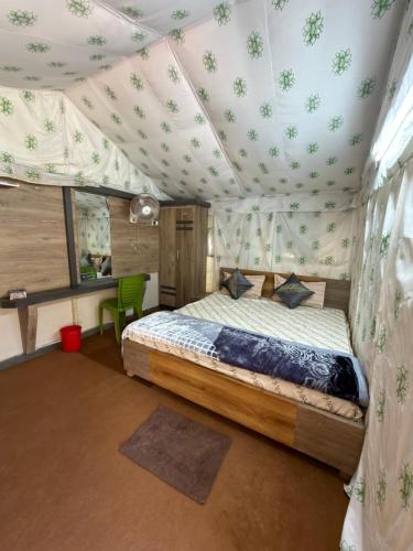 a bedroom with a bed in a tent at Palashbhumi Resort in Barhanti