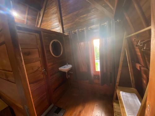 a small bathroom with a sink and a mirror at Pondok DG and Spa in Munduk