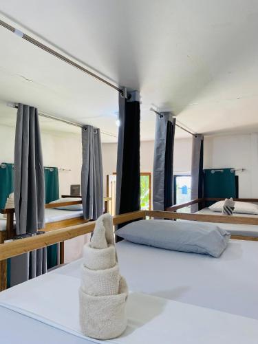 a bedroom with two beds and a towel on the floor at Hidden Grove GuestHouse in General Luna