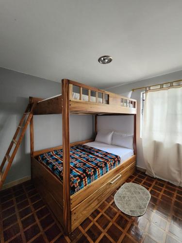 a bedroom with two bunk beds and a ladder at Rincón del Descanso in Loja
