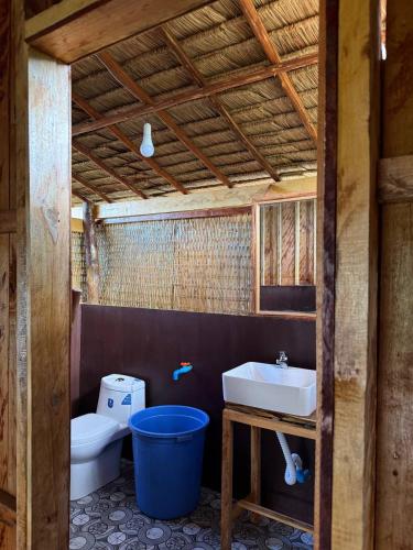 a bathroom with a toilet and a sink and a tub at Lily's Beach Bungalows in Koh Rong Island