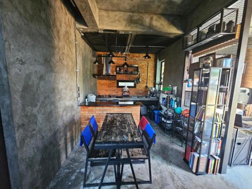 a dining room with a table and blue chairs at Navy Medic 36 Poolvilla in Sattahip