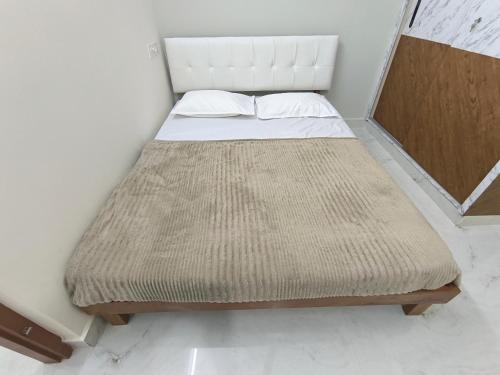 a bed in a room with a large mattress at BroFlats in Bangalore