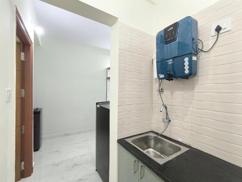a bathroom with a sink in a room at BroFlats in Bangalore