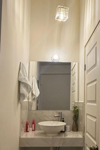 a bathroom with a white sink and a mirror at Loft Corceles 1, Zona Bonita in Hermosillo
