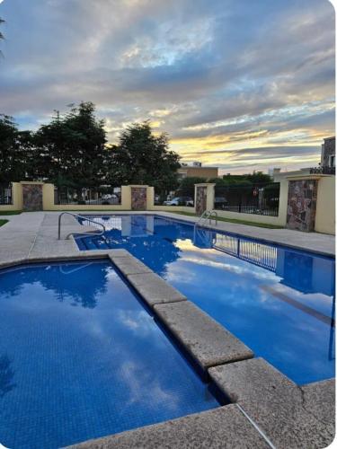 a swimming pool with blue water in a building at Loft Corceles 1, Zona Bonita in Hermosillo