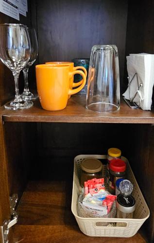 a shelf with a cup and a wine glass at Loft Corceles 1, Zona Bonita in Hermosillo