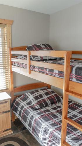 a bedroom with two bunk beds in a room at Legacy Vacation Rental in Valemount