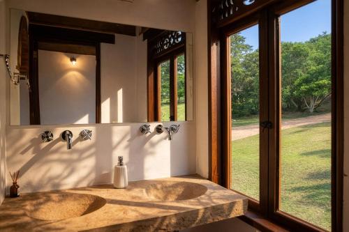 a bathroom with two sinks and a large mirror at Hacienda Cascanueces in Villa de Leyva