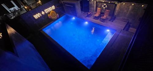 an overhead view of a swimming pool at night at Navy Medic 36 Poolvilla in Sattahip