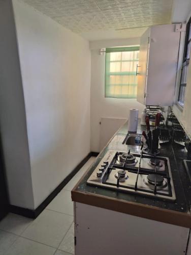 a kitchen with a stove top oven in a kitchen at Optimum Apartments in Providence
