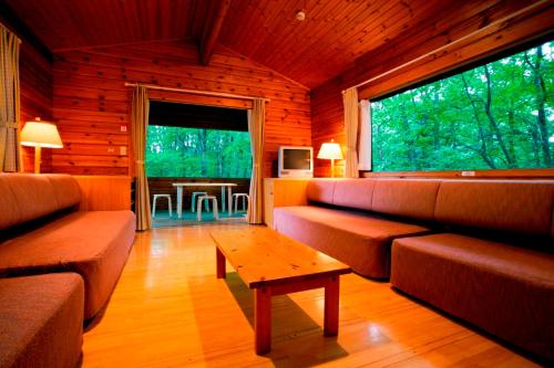 a living room with couches and a coffee table at PICA Chichibu in Chichibu