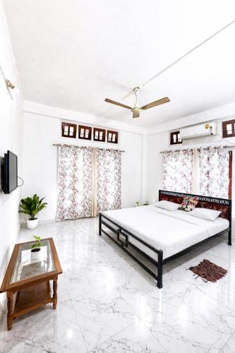 a bedroom with a bed and a coffee table at Puspalay Homestay in Guwahati