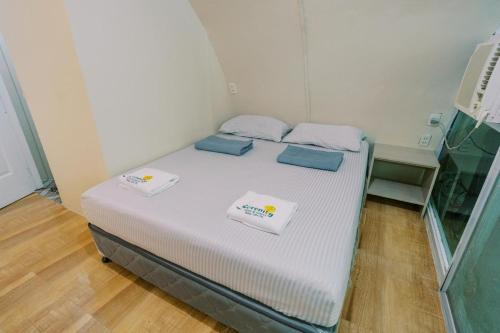 a bed in a room with two pillows on it at Serenity Busay Room 8 in Cebu City