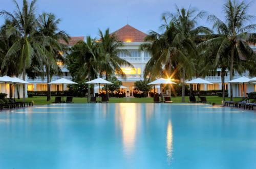 a large swimming pool in front of a hotel at Boutique Hoi An Resort in Hoi An
