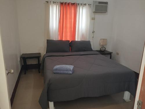 a bedroom with a large bed in front of a window at Tayud Hotel by Hiverooms in Liloan