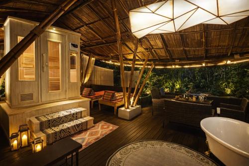 a bathroom with a bath tub and a sink at cooldowns resort maerim chiangmai in Ban Thung Pong